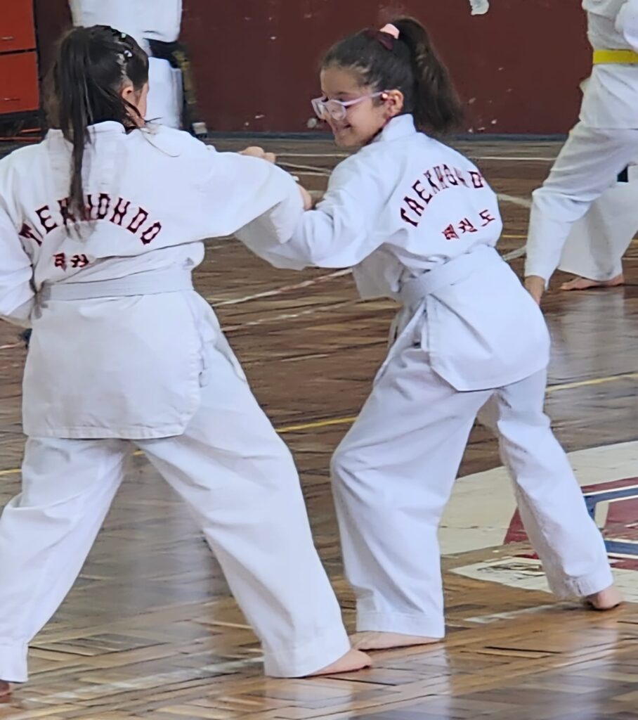 Niñas divirtiéndose y practicando taekwondo en Olimpic Atenas