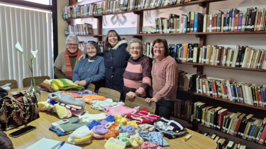 Grupo Arañitas Unidas de Minas, con varias de las prendas prontas para donar